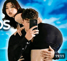 a man is carrying a woman on his back and taking a picture