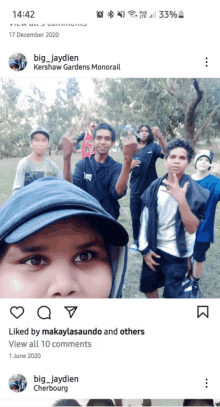 a group of young men are posing for a picture in a park and the time is 14:42