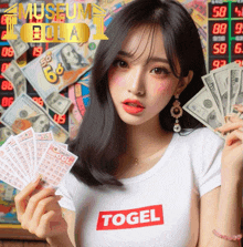 a woman wearing a white shirt that says ' togel ' on the front