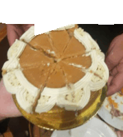 a person is holding a cake with a slice missing