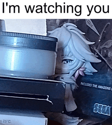 a stack of boxes with the words " i 'm watching you " on top