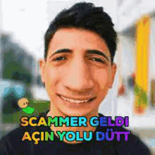 a young man is smiling and making a funny face with the words scammer geldi acin yolu dutt .