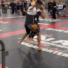 a man is standing on a mat that says warrior fighter on it