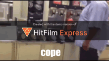 a man standing in front of a machine that says hitfilm express cope