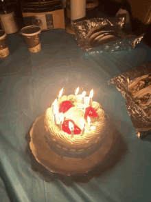 a birthday cake with candles on a table