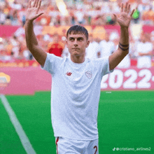 a soccer player in a white jersey with the number 2 on it