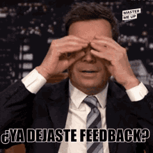 a man in a suit and tie is covering his eyes with his hands and says ya dejaste feedback ?