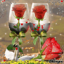 a picture of two wine glasses with roses and a swan