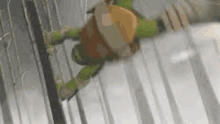 a teenage mutant ninja turtle is doing a handstand on a pole .