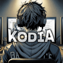 a man wearing headphones is sitting in front of a computer and the word kodia is displayed above him