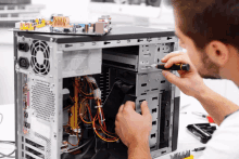 a man is working on a computer with a screwdriver and a sticker that says ' 8888 '