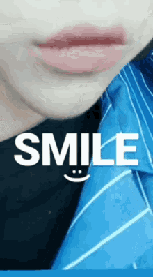 a close up of a person 's mouth with the word smile written on it