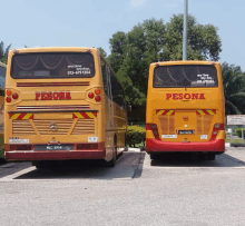 two pesona buses are parked next to each other in a parking lot