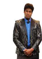 a man wearing a blue shirt and a black jacket with gold sequins