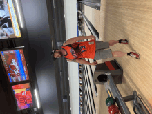 a man in a bowling alley with the number 21 on his shirt