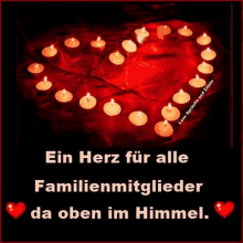 a picture of candles in the shape of a heart with the words ein herz for alle familienmitglieder da oben im himmel