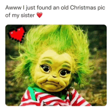 a picture of a baby grinch with green hair