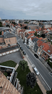 an aerial view of a city with a white van parked on the right side of the road