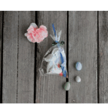 a small easter bunny in a clear plastic bag on a wooden table .