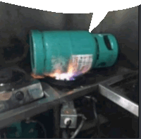 a green propane tank is sitting on a stove