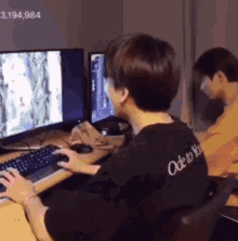 a man wearing a black shirt that says ode to you is playing a computer game .