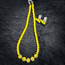 a necklace and earring set with yellow beads