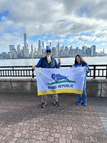 a man and a girl holding a rams republic flag