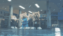 a group of teddy bears are standing in front of a gas station that says ufo