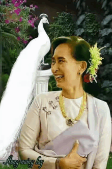 a woman stands next to a white peacock with the words jung naing lay written on the bottom