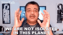 a man says " we are not isolated in this planet " with his hands in the air