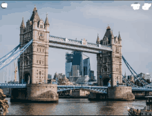 a bridge over a body of water with buildings in the background