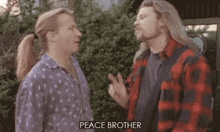 two men standing next to each other with the words peace brother written on the bottom