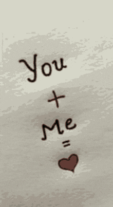 a drawing of the words you + me with a heart