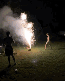 a man is standing in front of a firework display with a box that says ' r ' on it