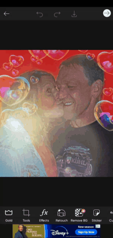 a man and a woman kissing with bubbles around them