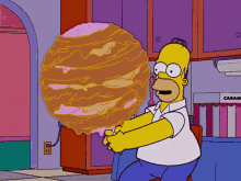 homer simpson holds a giant donut in his hands in front of a cabinet that says caramel