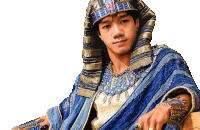 a man in a blue and gold costume with a pharaoh 's hat on his head