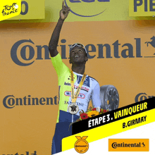 a man stands on a podium in front of a continental sign