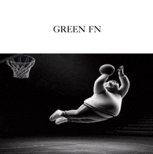 a black and white photo of a fat man playing basketball with the words green fn on the top