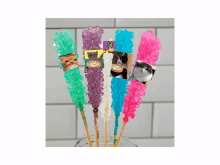 a bunch of colorful rock candy with pictures of cats on them