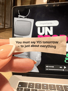 a person is holding a piece of paper that says " you must say yes tomorrow to just about everything "