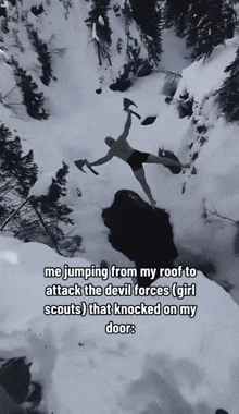 a black and white photo of a man jumping off a snow covered cliff