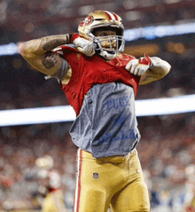 a football player wearing a helmet and a shirt that says budweiser