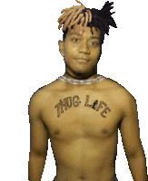 a shirtless man has a tattoo on his chest that reads thug life