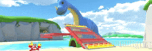 a blue dinosaur is standing on a beach next to a water slide .