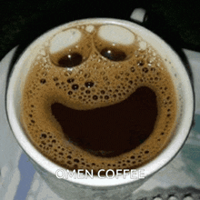 a cup of coffee that looks like a smiley face and says omen coffee on the bottom