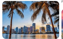 a picture of a city skyline with palm trees in the foreground and a river in the background .