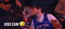 a man and woman kissing in a new york jersey