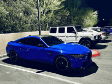 a blue sports car is parked next to a white jeep