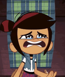 a cartoon girl is crying with a plaid blanket in the background